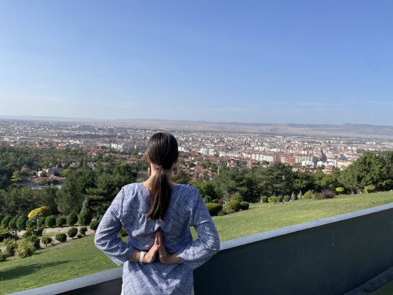 Prayer Hands while facing a city