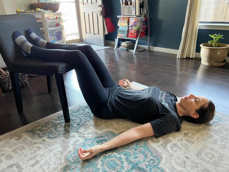 person resting with legs up on a chair